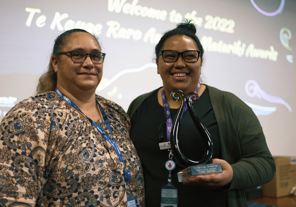 two people holding an award