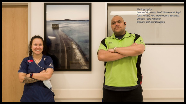 two staff members next to a beautiful photo