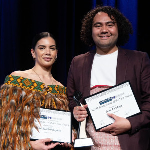 Two people with awards